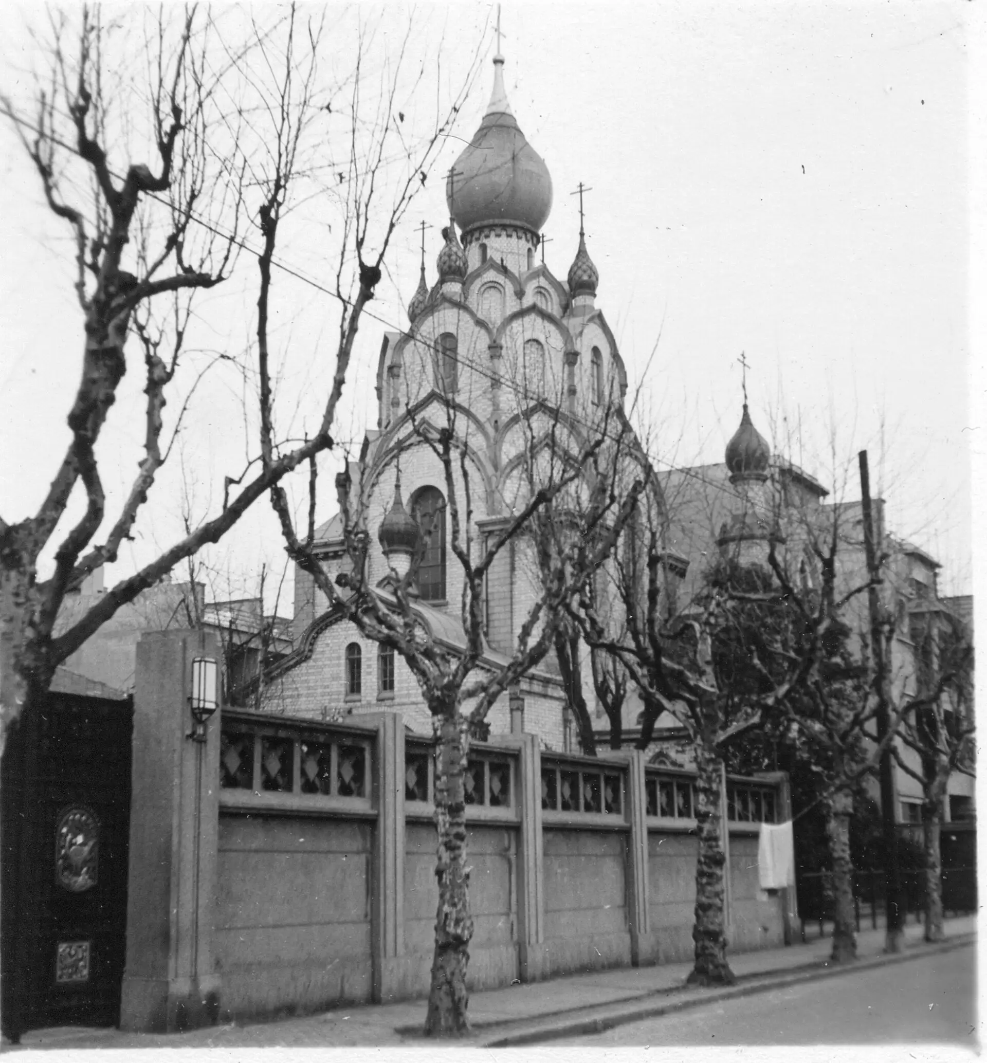 St Nicholas Church, a Russian Orthodox church with onion domes, behind bare trees, in the 1940s.