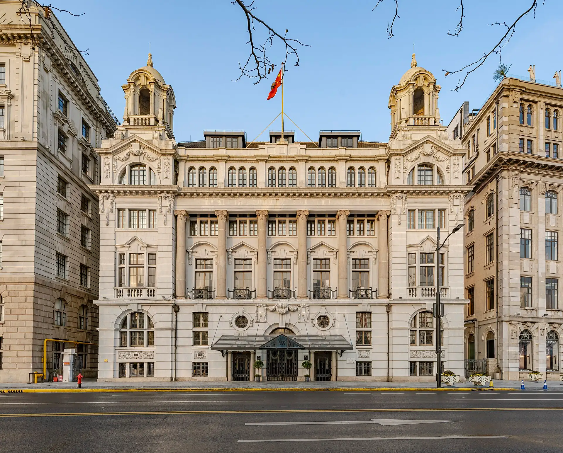 The Shanghai Club, a white Baroque façade with twin cupolas, seen from across the Bund road.