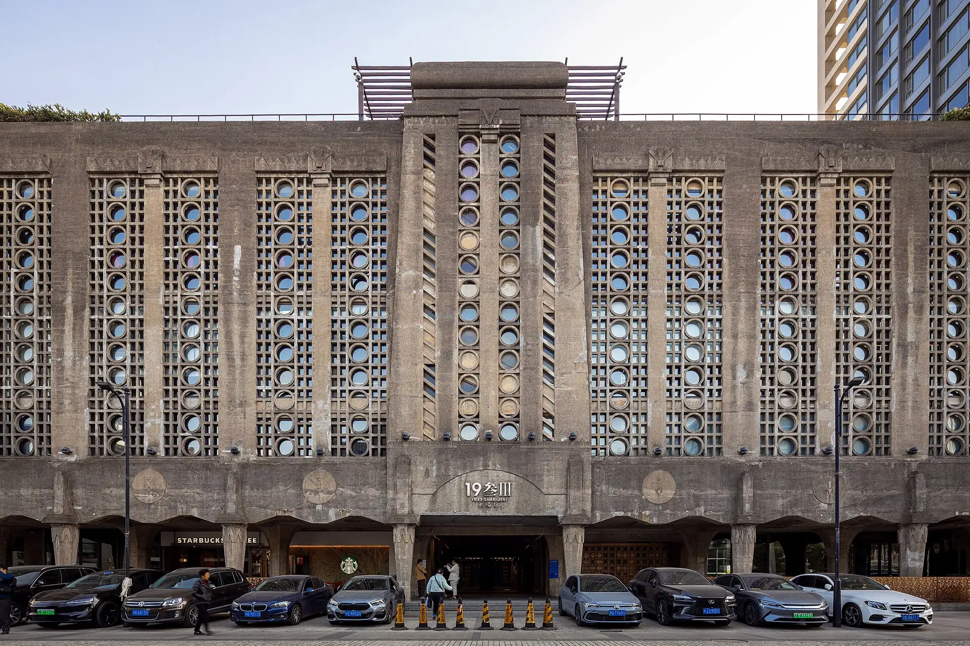 The 1933 Old Millfun façade, a concrete block with lattice windows.