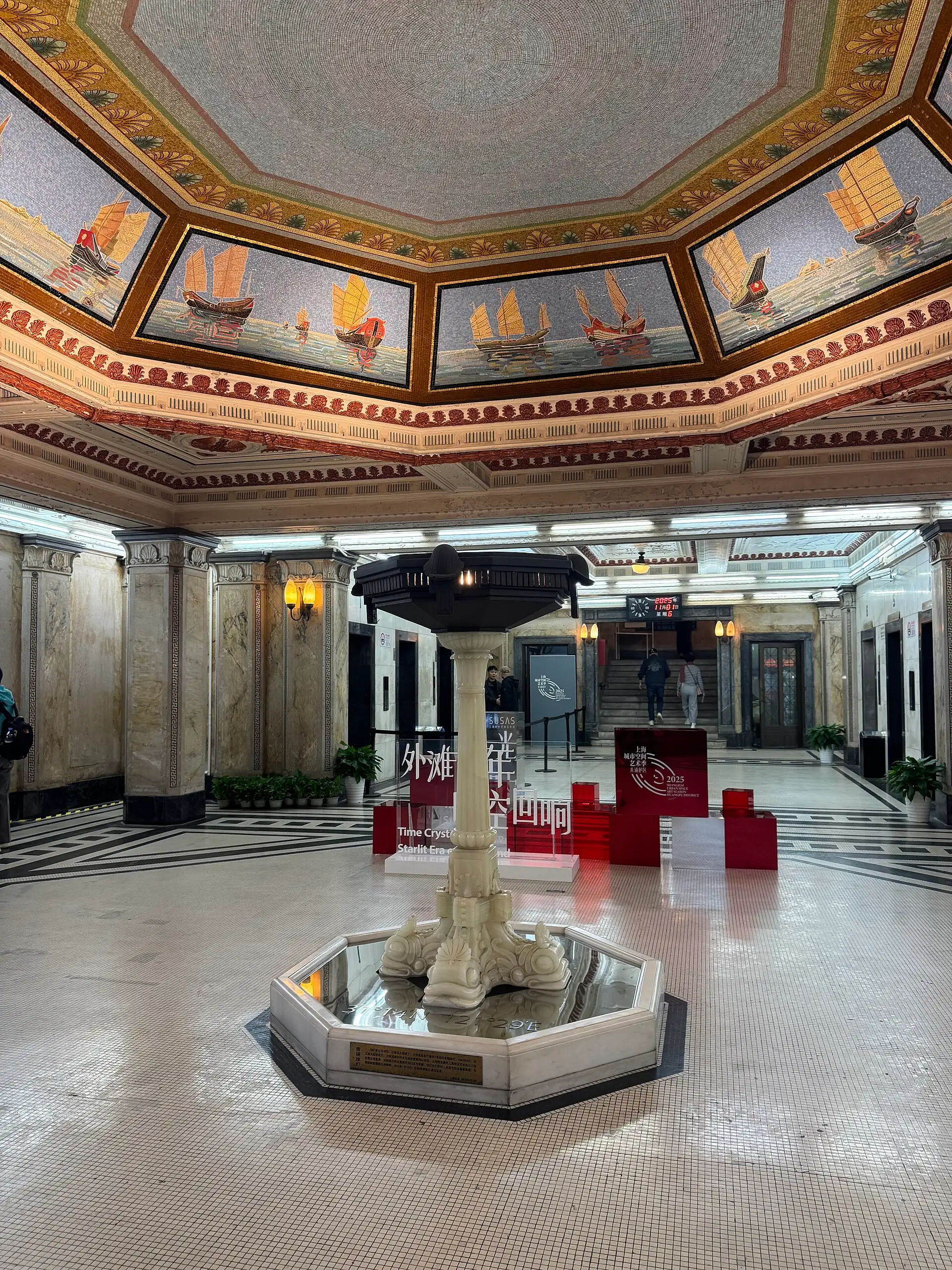 The Customs House entrance hall, with mosaic panels of sailing junks on the ceiling and a marble fountain.