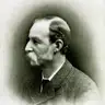 Black-and-white profile portrait of an older man with a white moustache and short beard, facing left, in a tweed jacket.