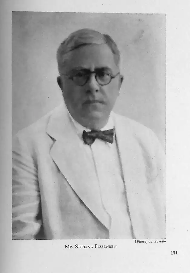 Black-and-white portrait of a man in round glasses, a white jacket and a bow tie, with a printed caption below.
