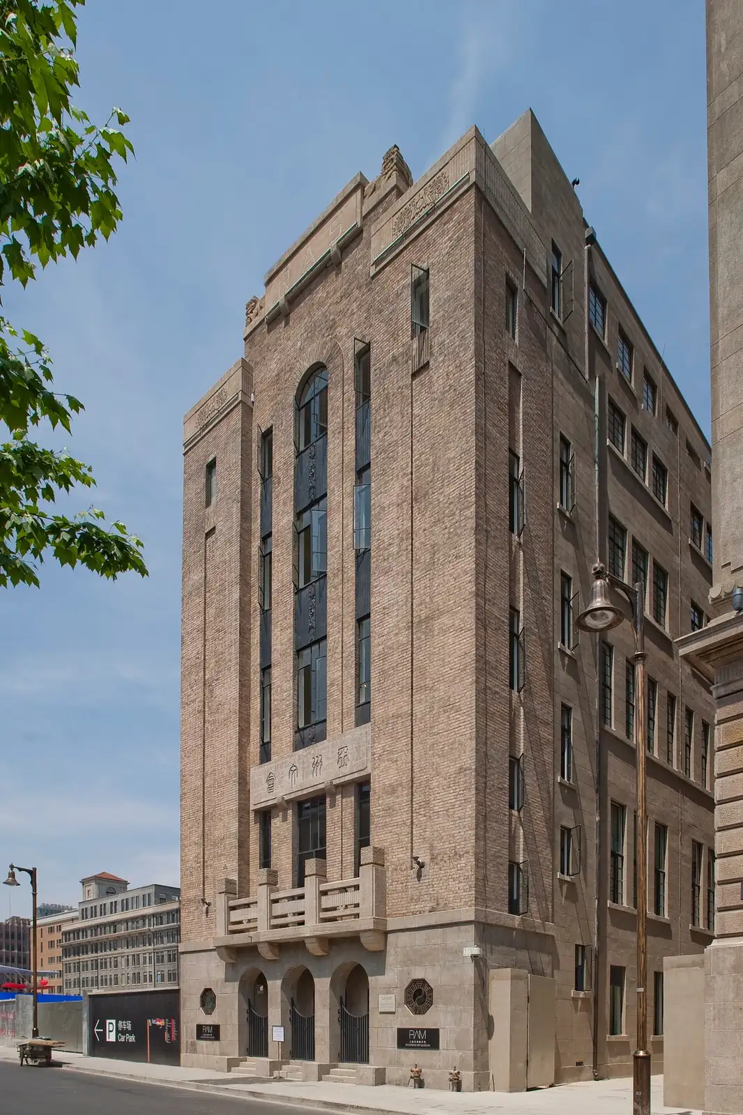 The tall stone corner facade of Rockbund Art Museum, with vertical windows and a ground-floor entrance.