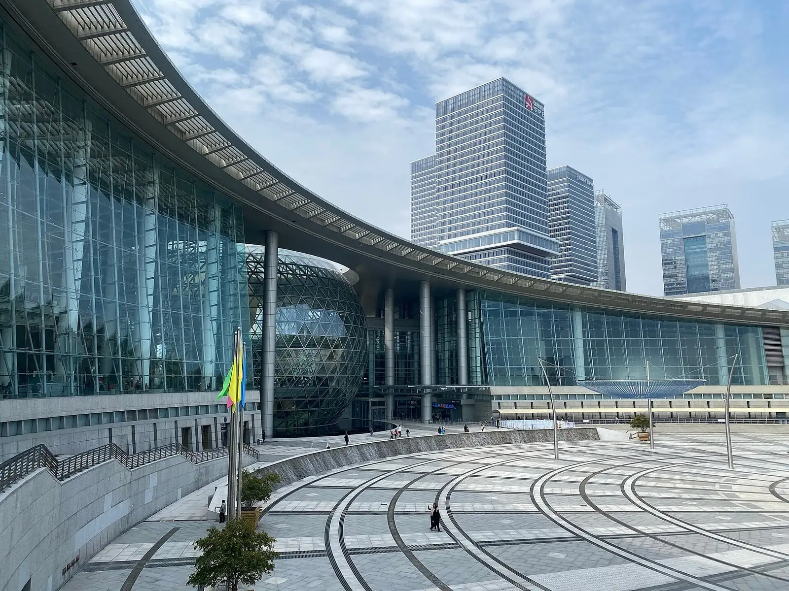 The curved glass facade and broad steps of Shanghai Science and Technology Museum.