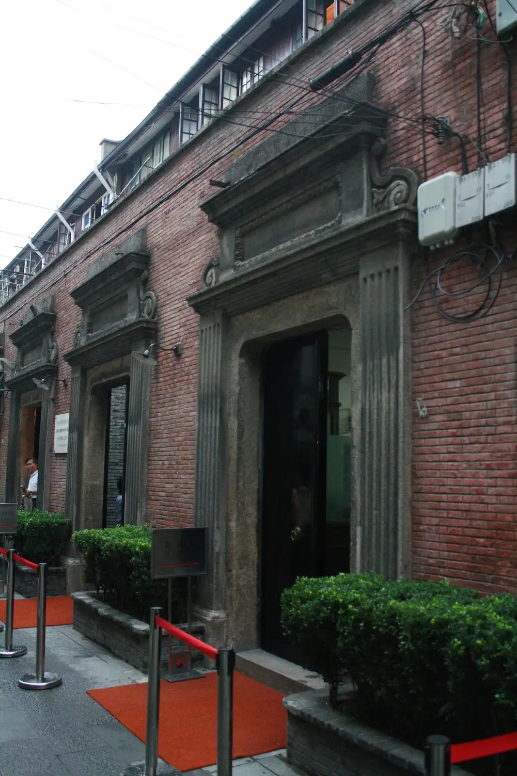 The brick entrance of the former Korean provisional government site, with a red rope barrier outside.