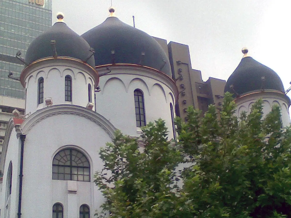 The white curved walls and dark domes of the Russian Orthodox Cathedral of the Mother of God.