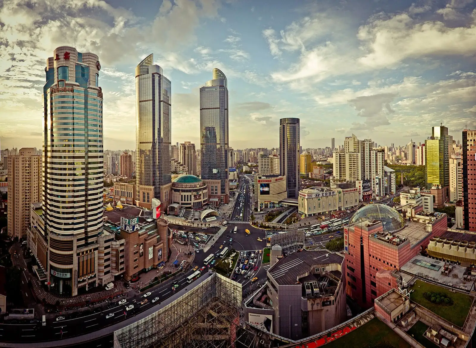 The Xujiahui shopping district, with tall commercial buildings, large shop signs and roads curving through the junction.